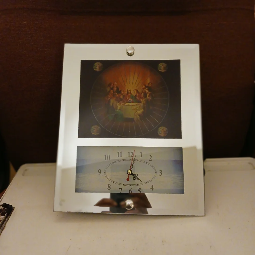 Elegant Silver Wall Clock with Religious Art